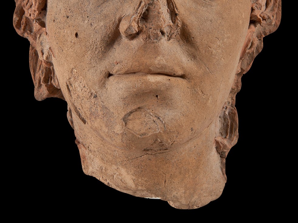 Testa di statua di uomo giovane